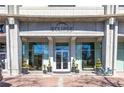Modern building entrance with manicured greenery and clear glass doors showcasing a welcoming interior at 250 Pharr Ne Rd # 2101, Atlanta, GA 30305