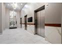 Hallway with modern elevators, marble accents, contemporary lighting, and sleek finishes at 250 Pharr Ne Rd # 2101, Atlanta, GA 30305