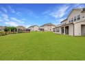 Extensive lawn in backyard with covered patio, ideal for outdoor activities and entertaining at 4720 Gablestone Xing, Hoschton, GA 30548