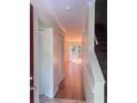 Bright hallway featuring hardwood floors, a closet, and a sliding glass door to a deck area at 4006 Bayside Cir, Atlanta, GA 30340