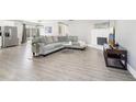 Bright living room featuring a comfortable gray sofa, fireplace, large TV, and stylish decor at 5722 Woodvalley Trce, Norcross, GA 30071