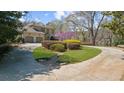 A sprawling lawn and circular driveway highlight this grand home's inviting exterior at 9860 Coleman Rd, Roswell, GA 30075