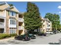 Exterior of Bentley Place showing well-maintained building, landscaping, and parking at 112 Bentley Pl, Tucker, GA 30084