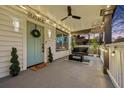 Relaxing front porch with a swing, string lights, and stylish decorations at 503 Mcwilliams Se Rd, Atlanta, GA 30315
