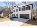 Stunning two-story home offers a sleek design with black trim and an attached garage with modern style at 1205 Cottonwood Se Grv, Conyers, GA 30094