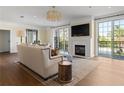 Sun-drenched living room with fireplace, hardwood floors, and balcony access at 3101 Howell Mill Nw Rd # 201, Atlanta, GA 30327