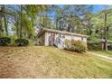 Front yard view of a charming home with a freshly painted exterior and a red front door at 3656 Tulip Dr, Decatur, GA 30032