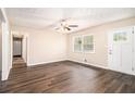 Bright living room with wood-look floors, neutral walls, and a front door with glass panes at 3656 Tulip Dr, Decatur, GA 30032