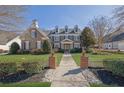 Inviting home exterior featuring a lush lawn and stately brick and stone accents at 3740 Williams Point Dr, Cumming, GA 30028
