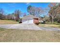 Two car detached garage with concrete drive on a well maintained lawn at 1420 Stephenson Rd, Lithonia, GA 30058
