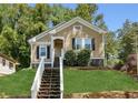 Charming home with inviting front porch and a well-maintained lawn at 1615 Orlando Sw St, Atlanta, GA 30311