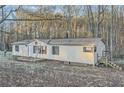 Single story home featuring a star on the front, surrounded by trees and an ample front yard at 355 Double D Rd, Temple, GA 30179