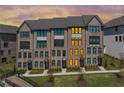 Modern townhome showcasing brick facade, black trim, and lush landscaping at 6701 Prelude Dr, Atlanta, GA 30328