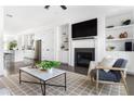 Bright living room featuring fireplace, built-in shelves, and sleek furniture at 6701 Prelude Dr, Atlanta, GA 30328