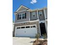 Exterior shot of a townhouse, showcasing a brick and siding facade, and an attached garage at 1180 Cades Walk, Lawrenceville, GA 30045