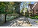 Gated driveway featuring a stone retaining wall providing privacy and security for the property at 1620 N Pelham Ne Rd, Atlanta, GA 30324