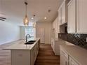 Kitchen featuring a spacious island, modern appliances and stylish backsplash at 1812 Emory Ln # 93, Conyers, GA 30013