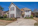 Inviting two-story home with red shutters, manicured landscaping, a stone facade, and a spacious driveway at 2134 Shropshire Se Ln, Atlanta, GA 30316
