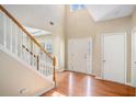 Bright foyer boasts hardwood floors, soaring ceilings, and a staircase with white railings and wooden accents at 2134 Shropshire Se Ln, Atlanta, GA 30316