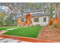 Attractive house exterior with a green lawn, wood detailing and an inviting front porch at 3637 Elm St, Atlanta, GA 30354