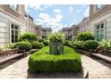 Beautiful courtyard with manicured hedges, benches, and stunning building facades at 2440 Peachtree Nw Rd # 1, Atlanta, GA 30305