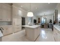 Gourmet kitchen boasts an island, wine fridge, and stainless appliances; perfect for entertaining at 2440 Peachtree Nw Rd # 1, Atlanta, GA 30305