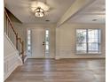 Inviting entryway with wood-look flooring, white trim, and natural light from the sidelight windows at 3550 Lakeheath Dr, Cumming, GA 30041