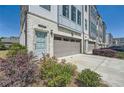 Attractive townhome exhibiting brick and siding, a well-manicured lawn, attached garage, and a welcoming entrance at 6187 Kelly Carlin Way, Norcross, GA 30071