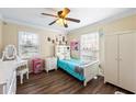 Cozy bedroom with wood floors, a ceiling fan, and natural light from the window at 2019 Wiltshire Pl, Snellville, GA 30078