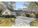 Lovely single Gathering home with stone accents, attached garage and large driveway at 2019 Wiltshire Pl, Snellville, GA 30078