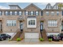 Brick townhomes featuring attached garages and professional landscaping at 2022 Raven Way, Atlanta, GA 30341