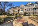 Charming brick townhomes showcasing well-maintained landscaping and a cozy fire pit at 2022 Raven Way, Atlanta, GA 30341