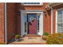 Close-up of the welcoming front door with wreath and decorative plants at 1030 Blankets Creek Dr, Canton, GA 30114