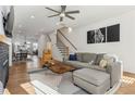 Bright living room with hardwood floors, a fireplace, ceiling fan, and direct access to the dining and kitchen areas at 2384 Provence Park Way, Decatur, GA 30033