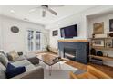 Comfortable living room with hardwood floors, fireplace, tv, and natural light filtering through french doors at 2384 Provence Park Way, Decatur, GA 30033