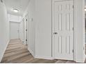 Neutral hallway featuring modern flooring and doors leading to various rooms at 9023 Stoneleigh Trce, Douglasville, GA 30134