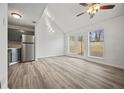 Bright living space with a vaulted ceiling, modern flooring, and sliding glass doors at 9023 Stoneleigh Trce, Douglasville, GA 30134
