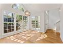 Sunlit dining room with large windows, wood floors, and modern lighting at 1661 Paddlewheel Dr, Marietta, GA 30062
