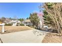 Well-maintained home featuring a long driveway and an attractive front yard with mature trees and landscaping at 189 Meadow Spring Dr, Temple, GA 30179
