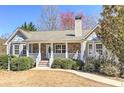 Inviting single-Gathering home with a covered porch, stone accents, manicured bushes, and a well-kept lawn at 189 Meadow Spring Dr, Temple, GA 30179