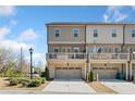 Townhome featuring a drive-under garage, second-floor deck, and neutral exterior paint at 1949 Skyfall Cir, Brookhaven, GA 30319
