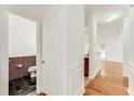 Hallway with hardwood floors that leads to the kitchen and bathroom at 2520 Laurel Nw Cir, Atlanta, GA 30311