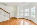 Bright living room featuring hardwood floors, large windows, and a staircase at 2520 Laurel Nw Cir, Atlanta, GA 30311
