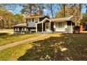 Traditional two-story home with a cozy front porch and neatly kept landscaping at 5505 Longmeadow Ln, College Park, GA 30349