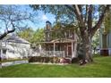 A charming two-story home with a spacious front yard and mature trees at 109 Bowen Sw Cir, Atlanta, GA 30315