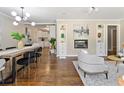 Open-concept living space with hardwood floors, built-in shelving, and modern lighting fixtures at 1703 Derrill Dr, Decatur, GA 30032