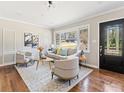 Cozy living room featuring hardwood floors, large windows, and comfortable seating arrangements at 1703 Derrill Dr, Decatur, GA 30032