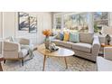Bright living room featuring a comfortable sofa, accent chairs, and a patterned rug at 1703 Derrill Dr, Decatur, GA 30032