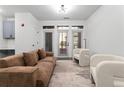 Bright living room featuring a couch, chairs, and access to an outdoor patio and work area at 400 17Th Nw St # 1133, Atlanta, GA 30363