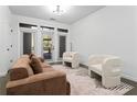 Bright living room featuring a couch, chairs, and access to an outdoor patio at 400 17Th Nw St # 1133, Atlanta, GA 30363